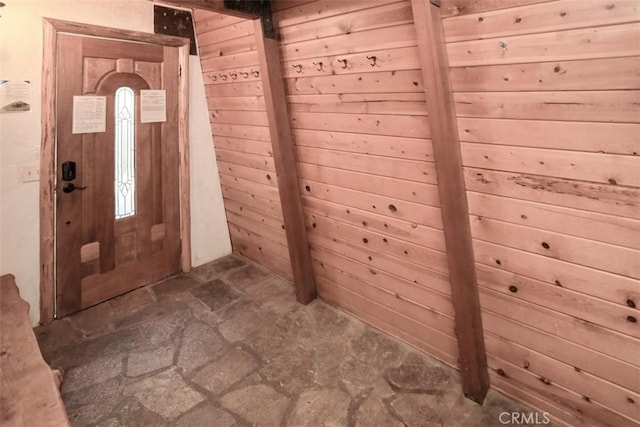 foyer entrance with wood walls