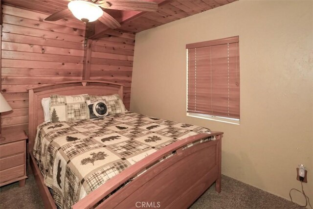 carpeted bedroom featuring ceiling fan and wood ceiling