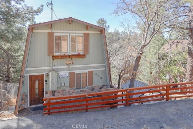 a-frame home featuring fence