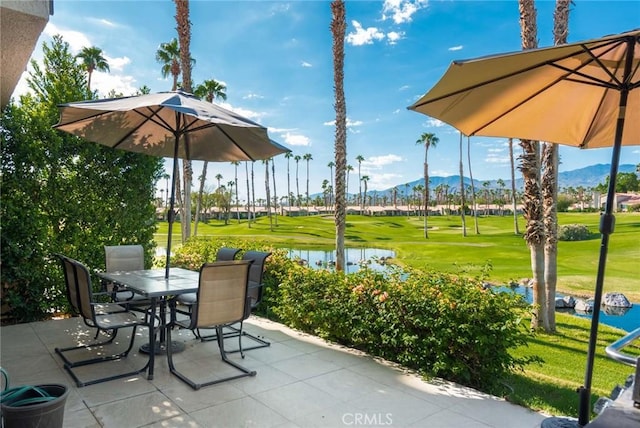 view of patio with a water and mountain view