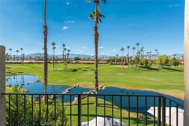 view of property's community featuring a water and mountain view and a yard