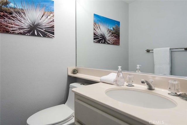 bathroom with toilet and vanity