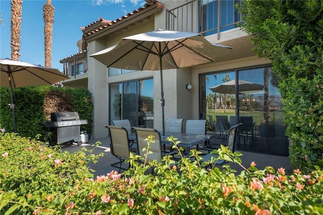 rear view of house with a patio area and a balcony