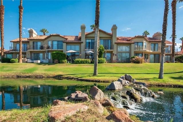 exterior space with a water view and a yard