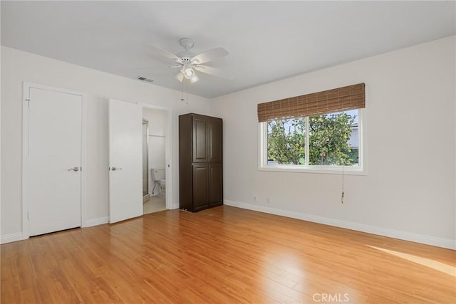 unfurnished bedroom featuring ceiling fan, connected bathroom, and light hardwood / wood-style flooring