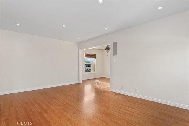 unfurnished room with ceiling fan and light wood-type flooring