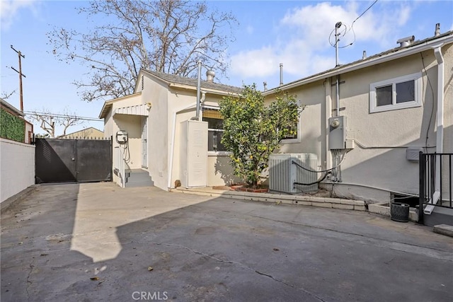 view of property exterior with a patio area and central AC