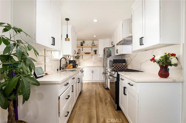 kitchen featuring stainless steel appliances, white cabinets, and hanging light fixtures