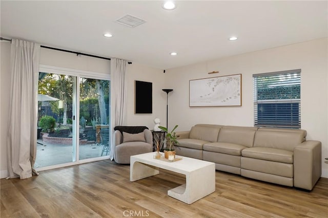 living room with light hardwood / wood-style flooring