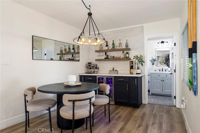 interior space featuring hardwood / wood-style flooring, hanging light fixtures, and beverage cooler