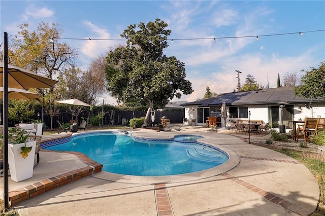 view of swimming pool with an in ground hot tub and a patio