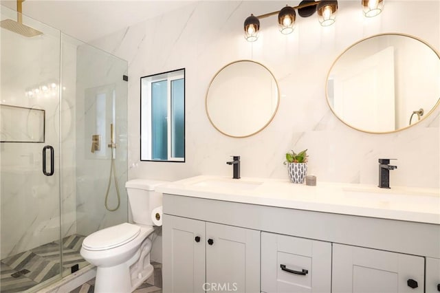 bathroom featuring a shower with shower door, toilet, and vanity