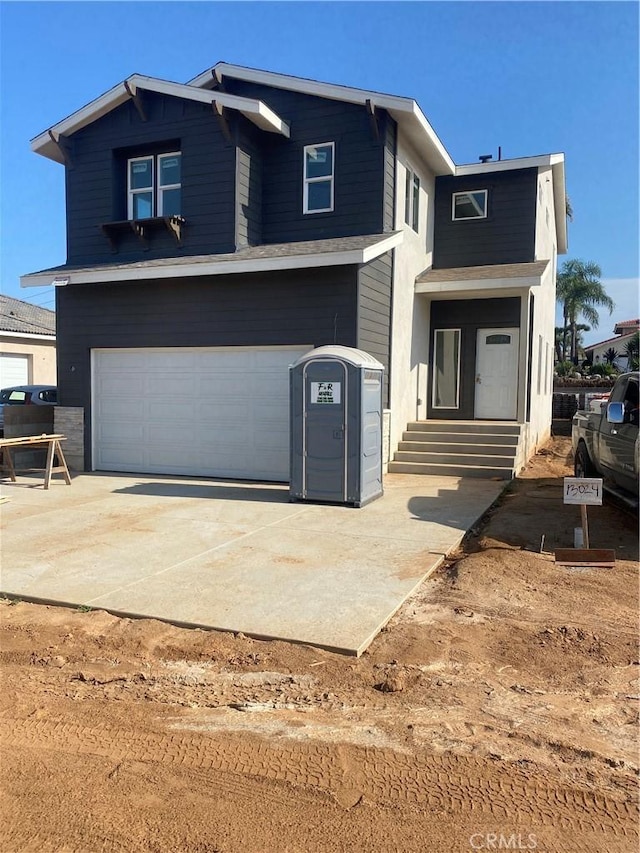 view of front of house with driveway, an attached garage, and entry steps