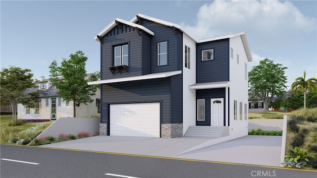 view of front of house featuring stone siding, an attached garage, and concrete driveway