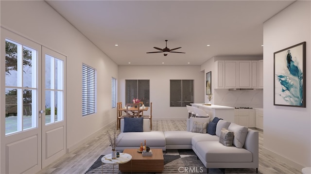 living room with light hardwood / wood-style flooring and ceiling fan