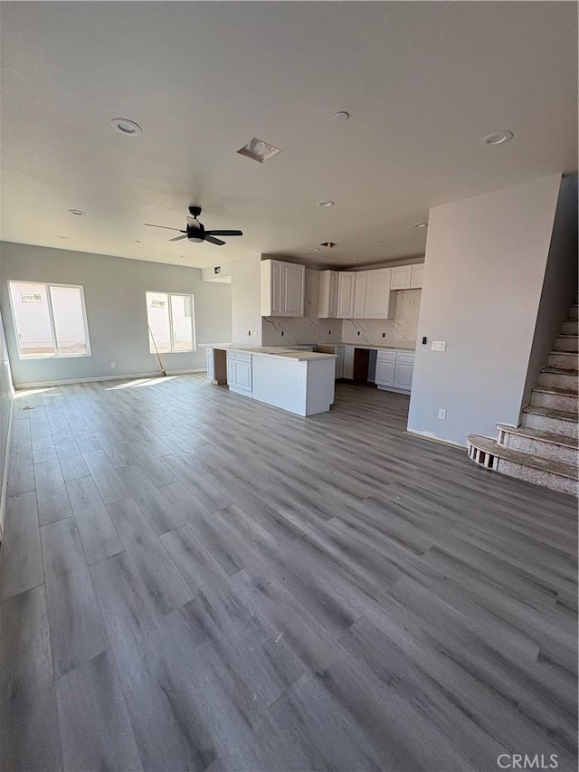 unfurnished living room featuring light hardwood / wood-style floors and ceiling fan