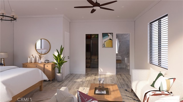 bedroom featuring ensuite bath, crown molding, a notable chandelier, and wood finished floors