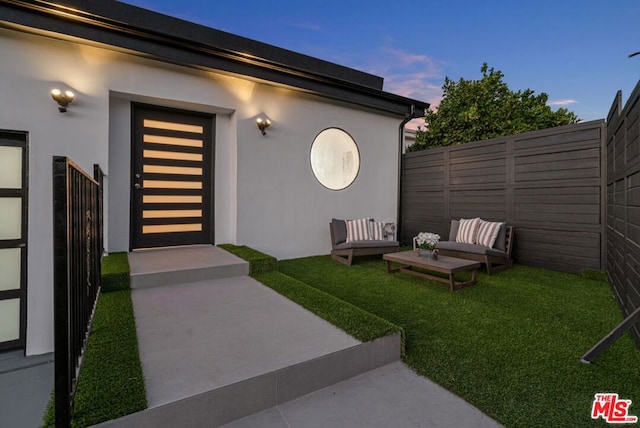 exterior entry at dusk with a yard