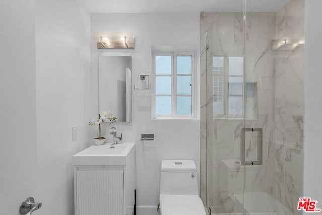 bathroom featuring vanity, an enclosed shower, and toilet