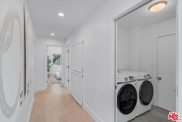 washroom featuring separate washer and dryer and light hardwood / wood-style floors