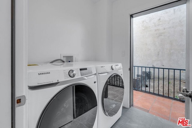 laundry room with tile patterned floors and washer and dryer