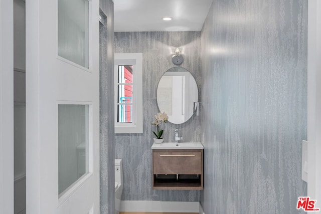 bathroom featuring vanity and toilet