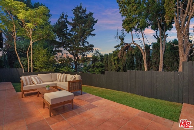 patio terrace at dusk featuring outdoor lounge area