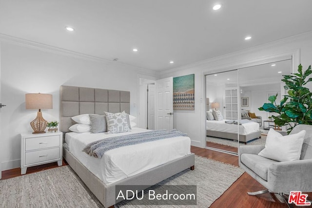 bedroom with hardwood / wood-style floors and ornamental molding