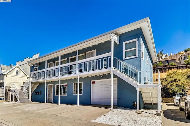 view of front of property featuring a garage and a balcony