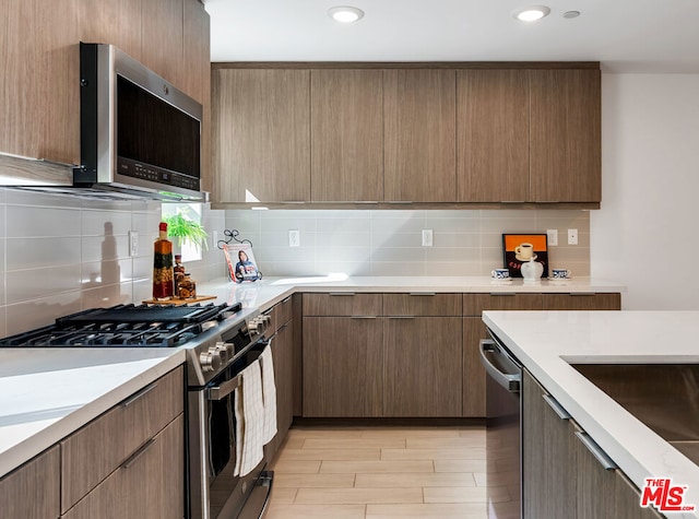 kitchen with backsplash and stainless steel appliances