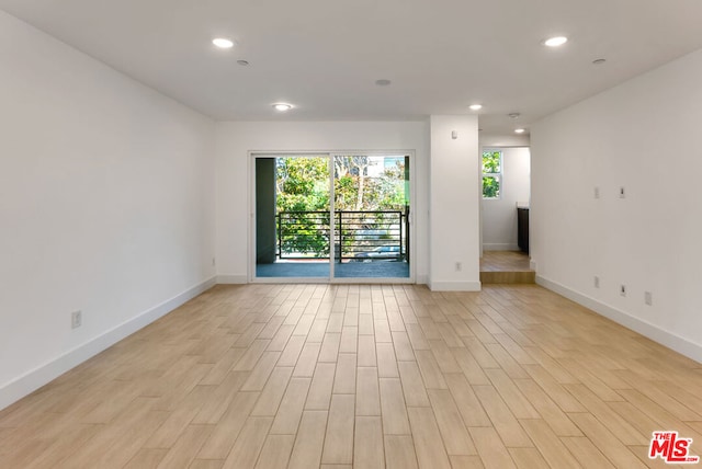 empty room with light hardwood / wood-style flooring