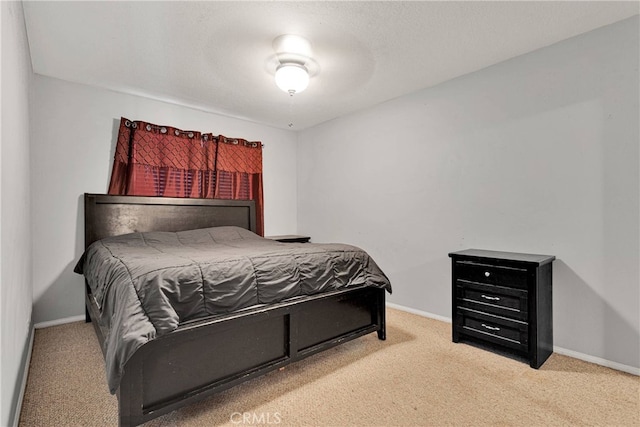 bedroom featuring light carpet