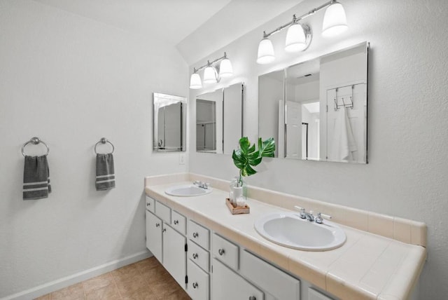 bathroom with tile patterned floors and vanity