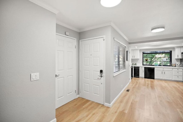 foyer entrance with crown molding, light hardwood / wood-style floors, and wine cooler