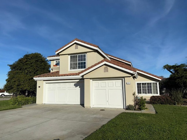 view of front of house with a garage and a front lawn