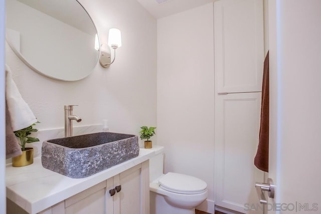 bathroom featuring toilet and vanity