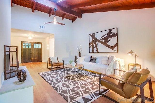 living room featuring ceiling fan, wooden ceiling, lofted ceiling with beams, and light wood-type flooring