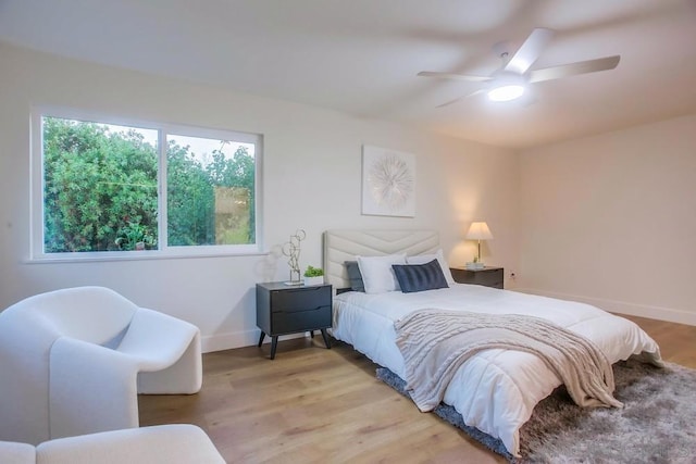 bedroom with ceiling fan and light hardwood / wood-style floors