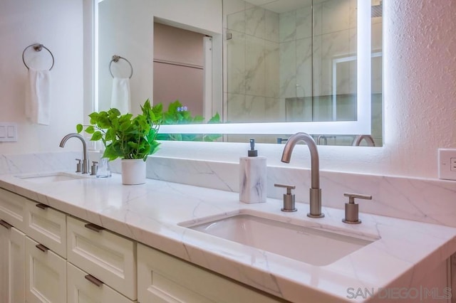 bathroom featuring an enclosed shower and vanity