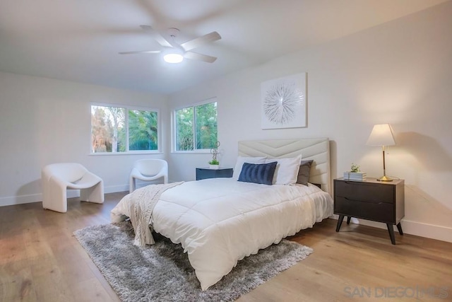 bedroom with ceiling fan and hardwood / wood-style flooring