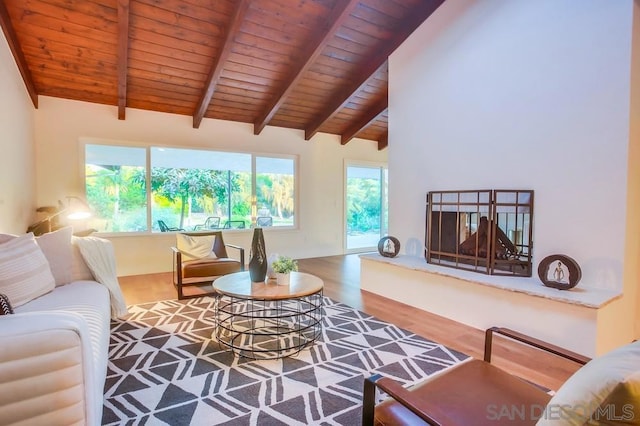 living room with hardwood / wood-style flooring, wood ceiling, and vaulted ceiling with beams