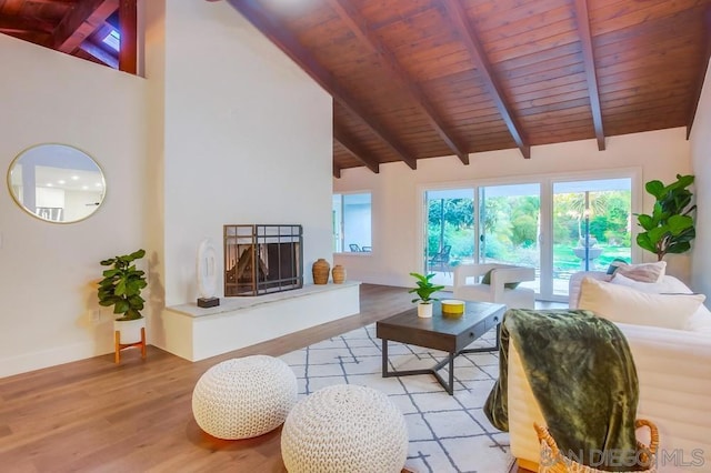 living room featuring light hardwood / wood-style floors, wooden ceiling, high vaulted ceiling, and beamed ceiling