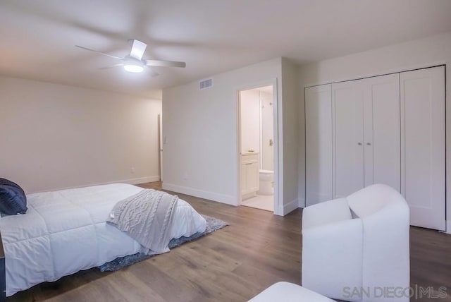 bedroom featuring ceiling fan, connected bathroom, hardwood / wood-style flooring, and a closet