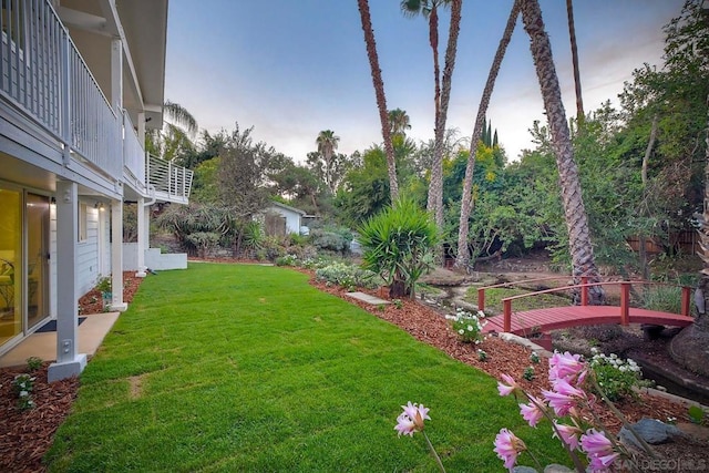 yard at dusk with a balcony