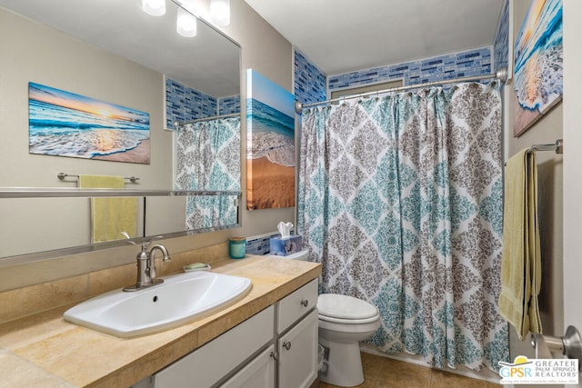 bathroom featuring toilet, a shower with shower curtain, tile patterned flooring, and vanity