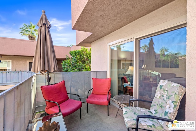 view of patio featuring a balcony