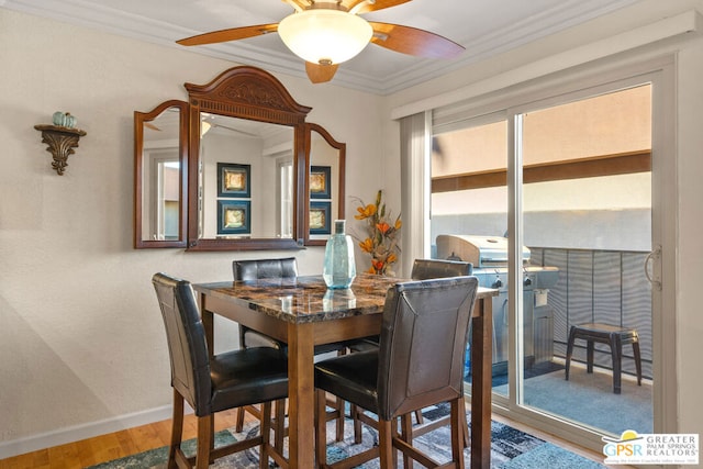 dining space featuring ceiling fan, hardwood / wood-style floors, and ornamental molding