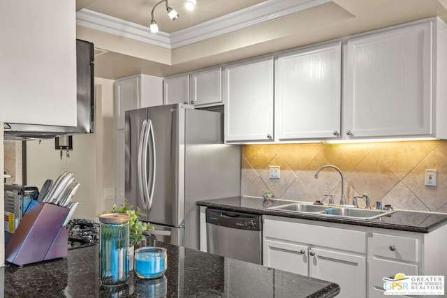 kitchen featuring stainless steel appliances, dark stone countertops, white cabinets, and sink