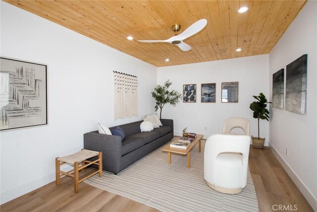 living room with ceiling fan, wood ceiling, and light wood-type flooring