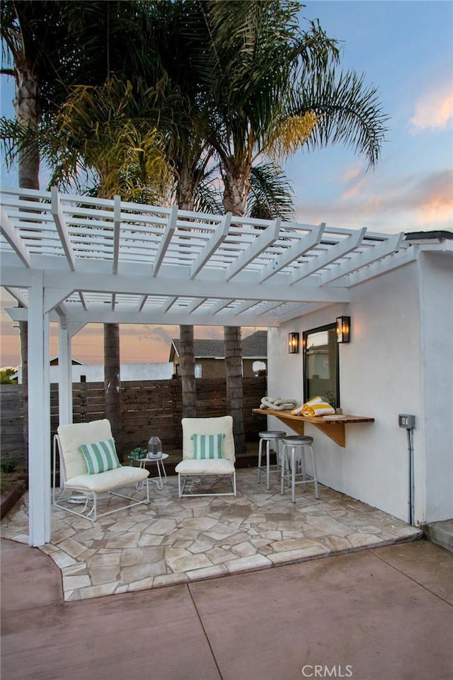 patio terrace at dusk with a pergola